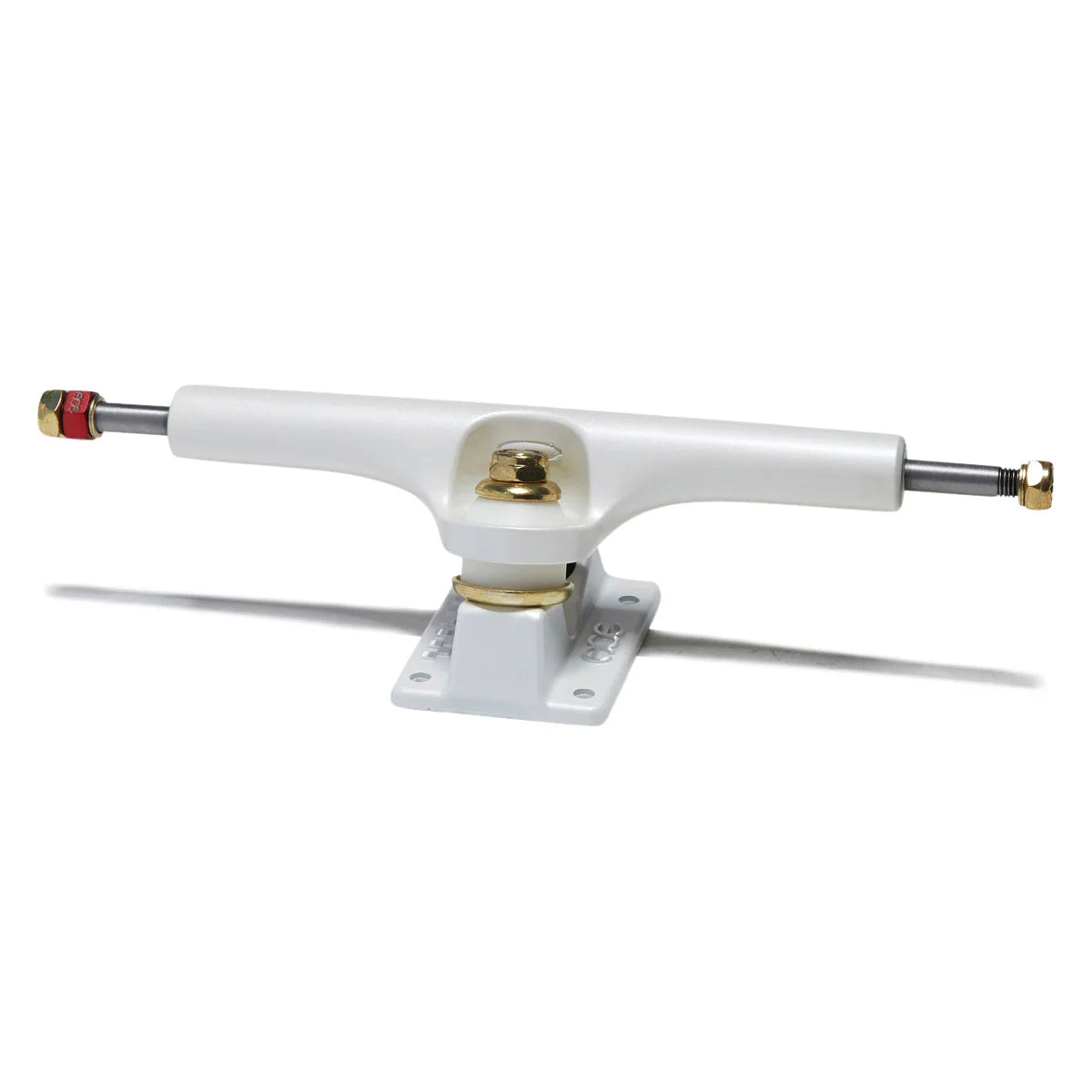 A single skateboard truck with a white polyurethane frame, gold-toned metal hardware, and silver metal axles with red and gold end caps, shown on a white background with a soft shadow.