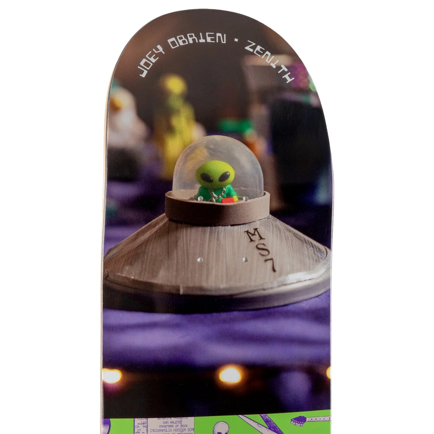 A skateboard deck featuring a graphic print of a green alien sitting in a dome inside a UFO, with the text 'JOEY obrien * ZENITH' printed along the top edge.