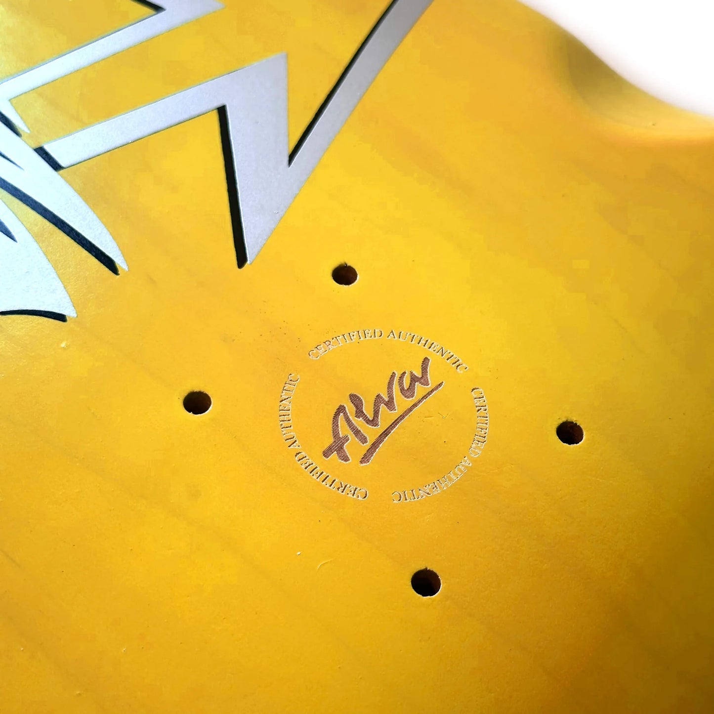 Close-up of a yellow object with a brand logo and text