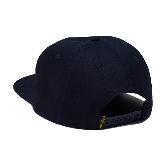 A dark navy blue snapback cap shown from a rear three-quarter angle on a plain white background, featuring a small yellow embroidered brand logo on the side of the black adjustable strap.