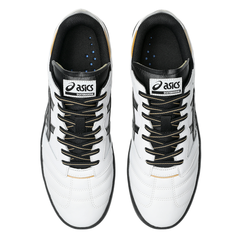 Pair of white and black Asics shoes on a light gray background