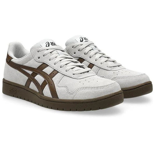 Gray sneakers with brown accents on a white background