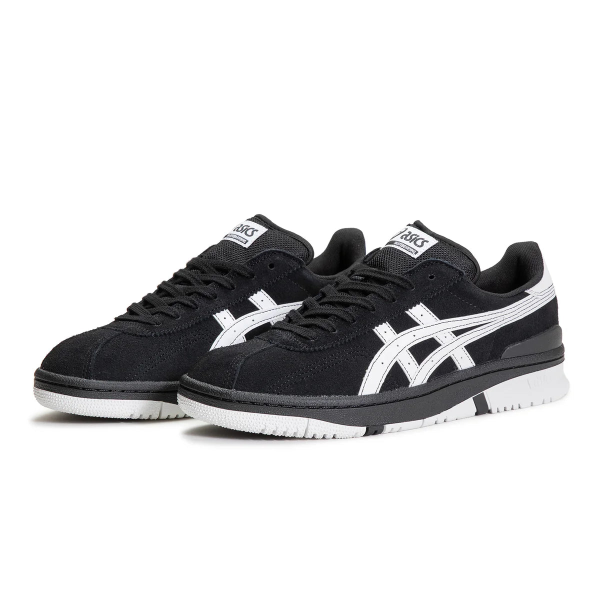 Black and white sneakers with a prominent brand logo on a white background