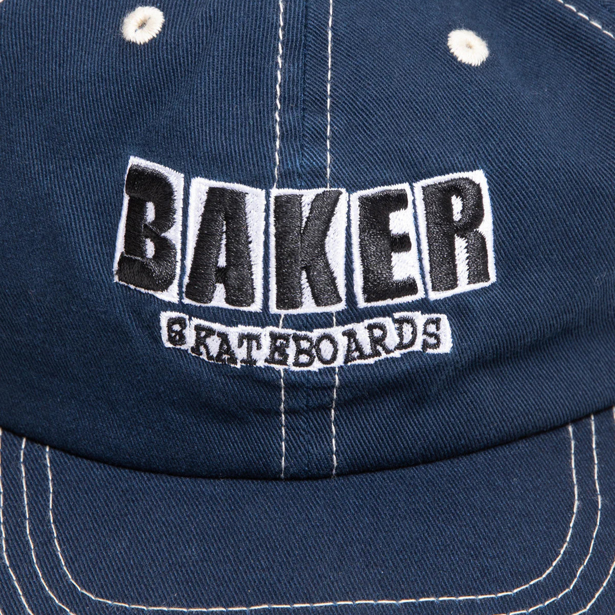 Navy blue cap with 'Baker Skateboards' logo on a close-up view