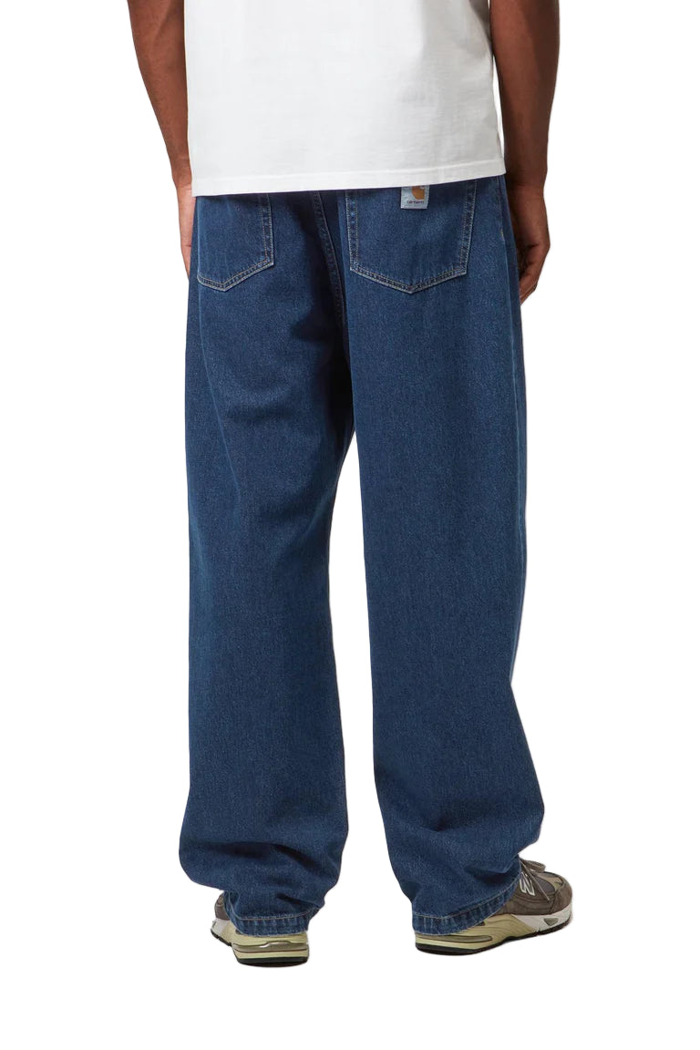 Person wearing blue jeans and a white shirt on a white background