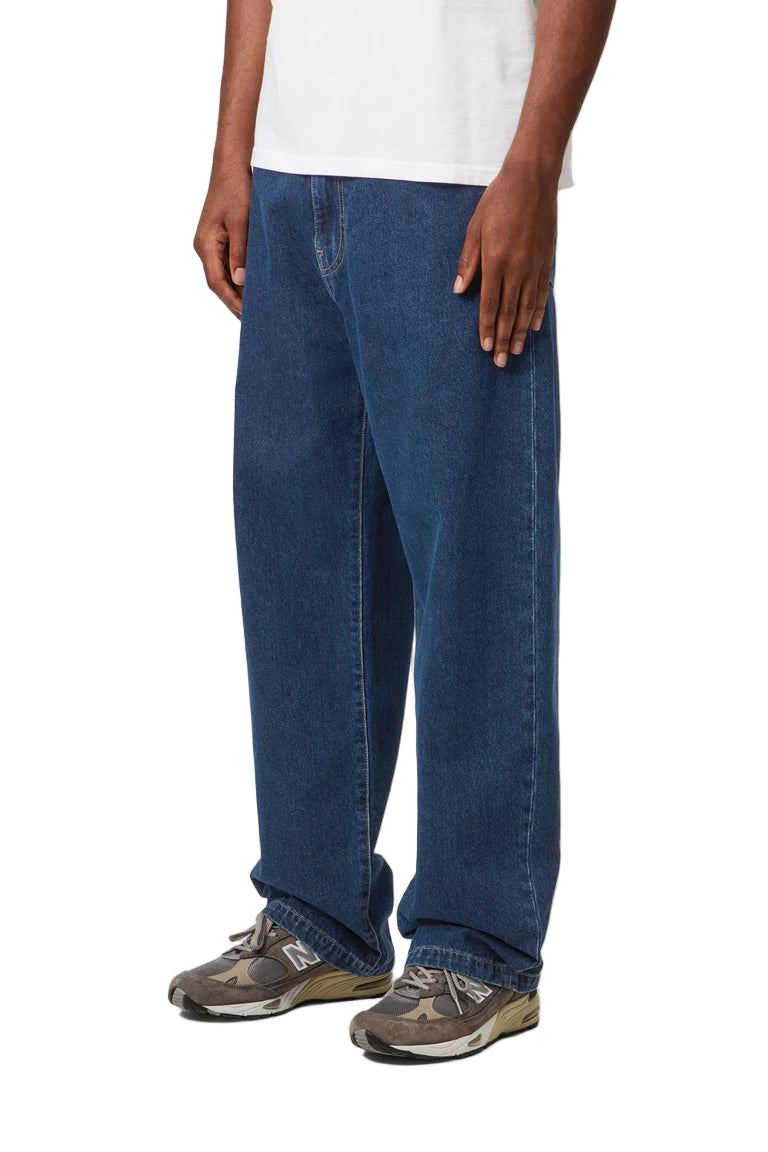 Person wearing blue jeans and a white shirt on a white background