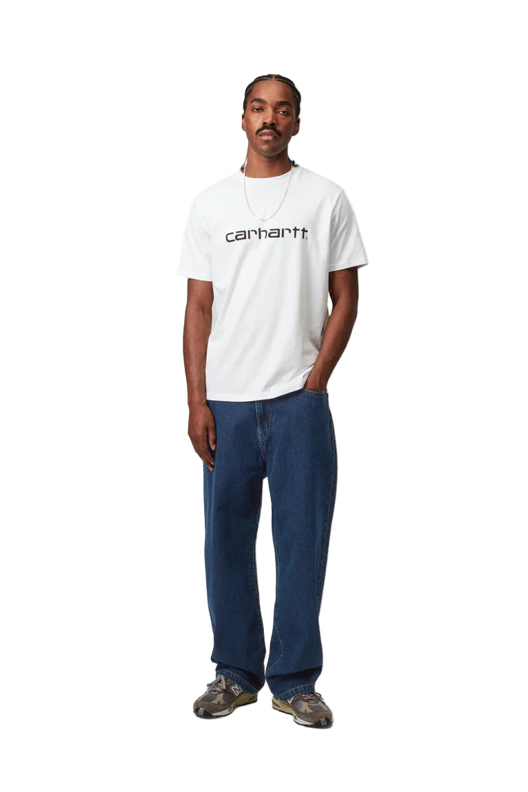 Person wearing a white t-shirt with a logo and blue jeans on a white background