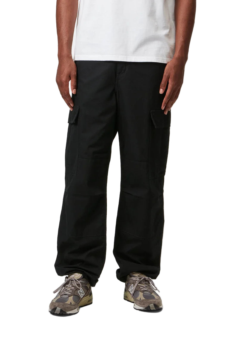 Person wearing black cargo pants on a white background