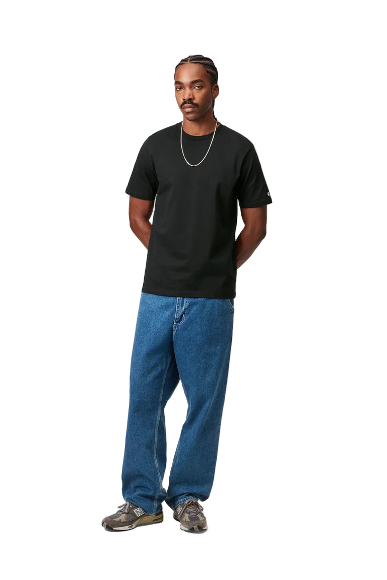 Person wearing a black t-shirt and blue jeans on a white background