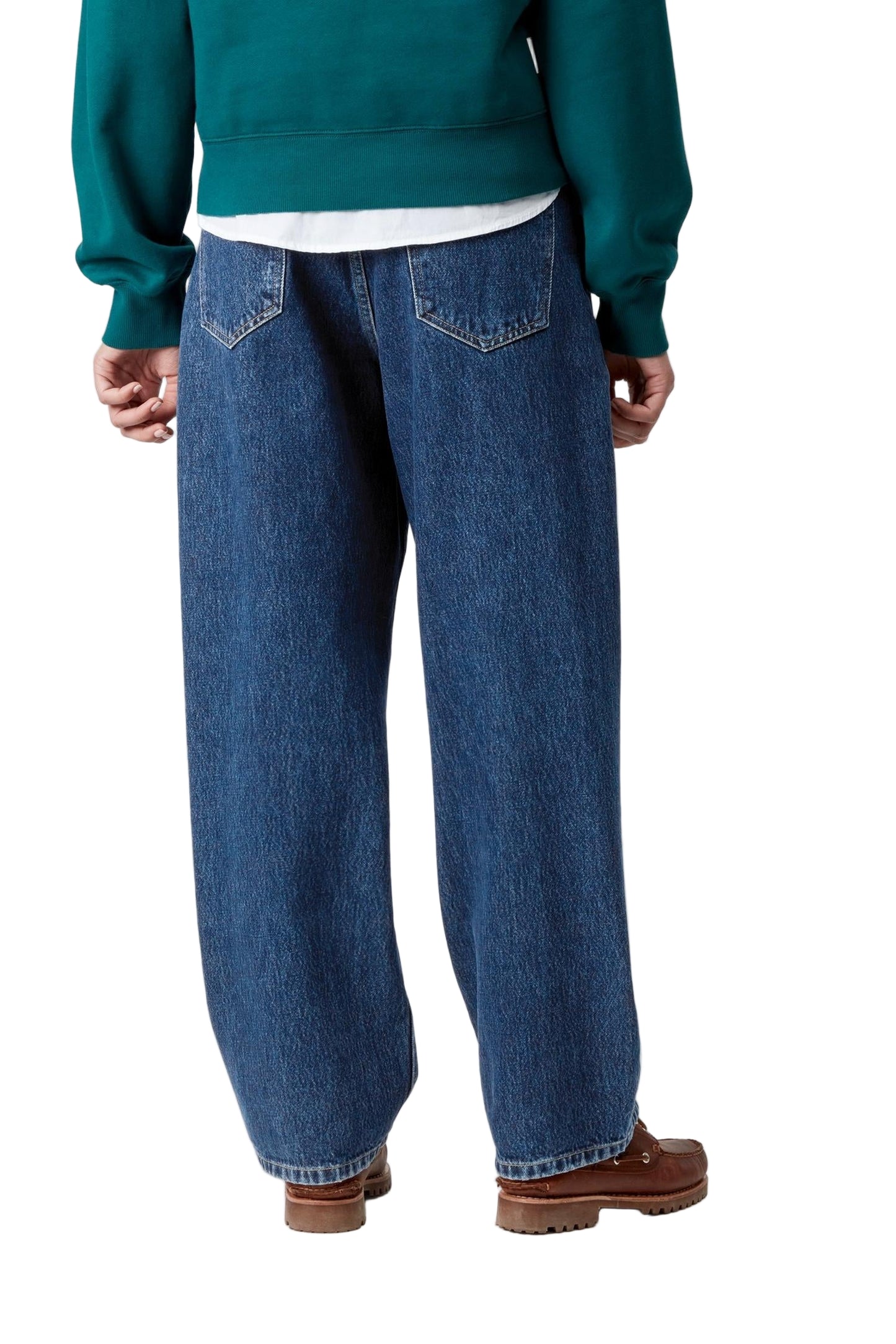 Person wearing blue jeans and a green sweater on a white background