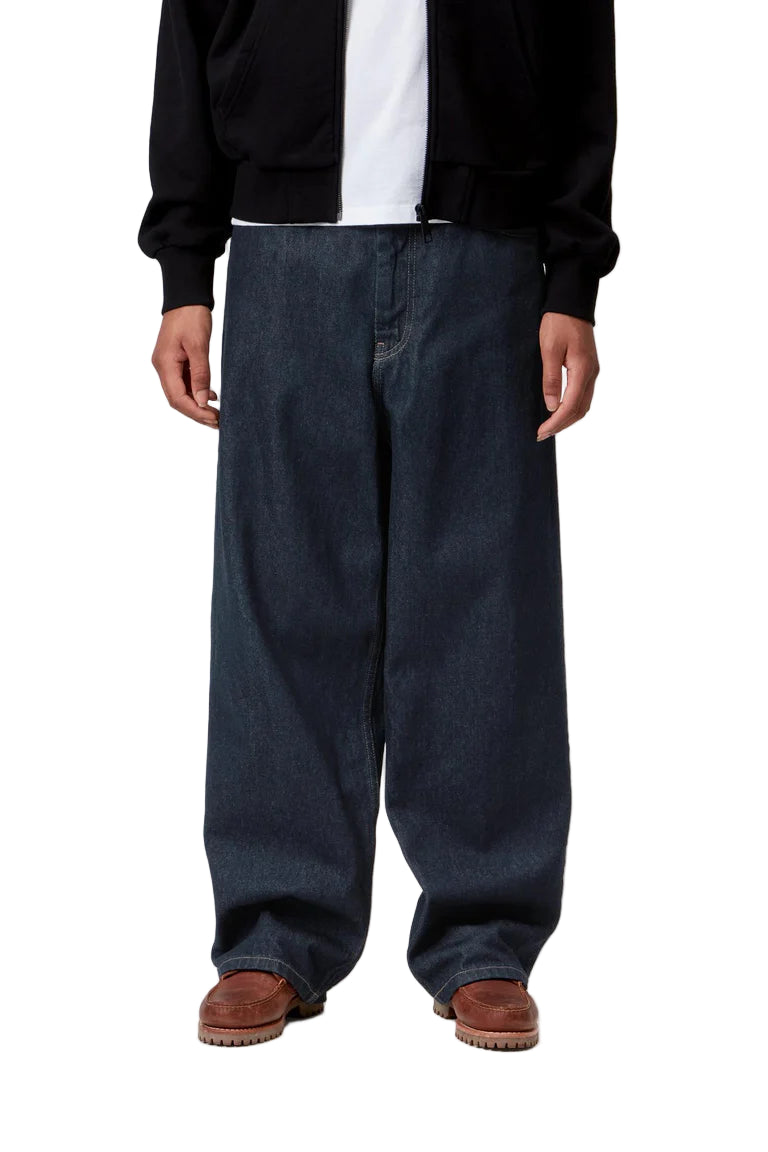 Person wearing dark blue jeans and a black jacket on a white background
