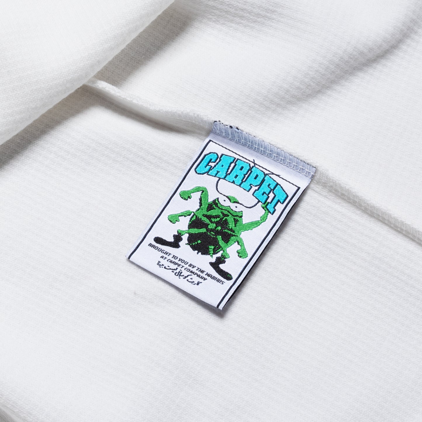 Label with a green spider design and 'Carpet' text on a white background