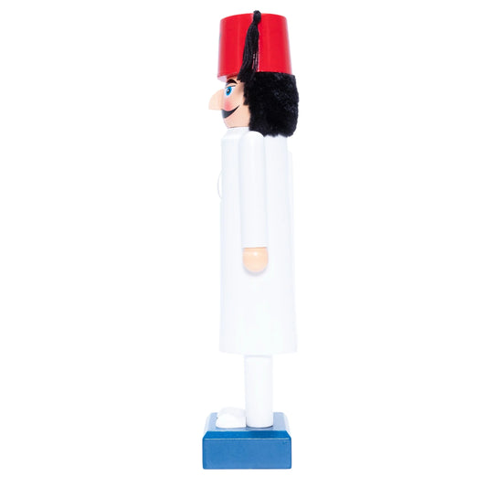 Nutcracker toy with a red hat and white outfit on a white background