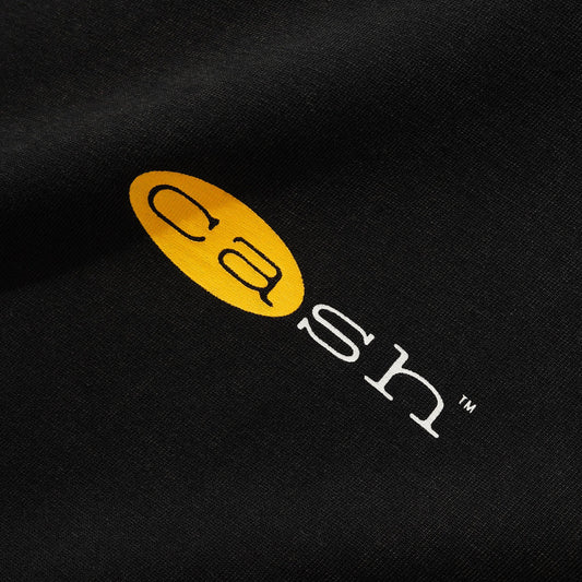 Black shirt with a yellow and white logo on a dark background
