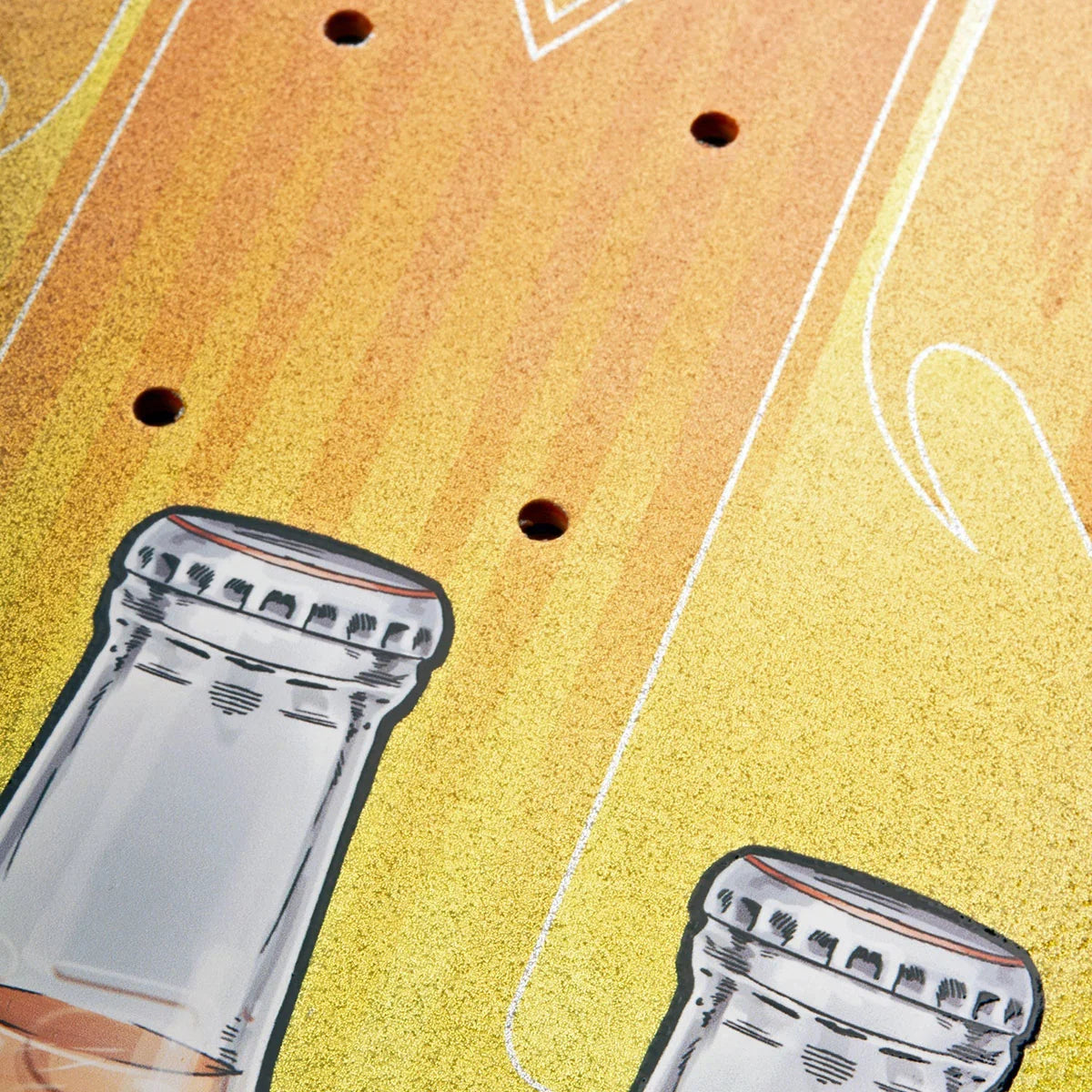 Close-up of a yellow-orange textured surface with small circular cutouts and partial illustrated bottle graphics.