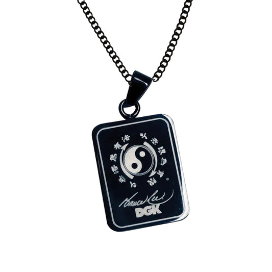 Black pendant necklace with yin yang symbol on a white background