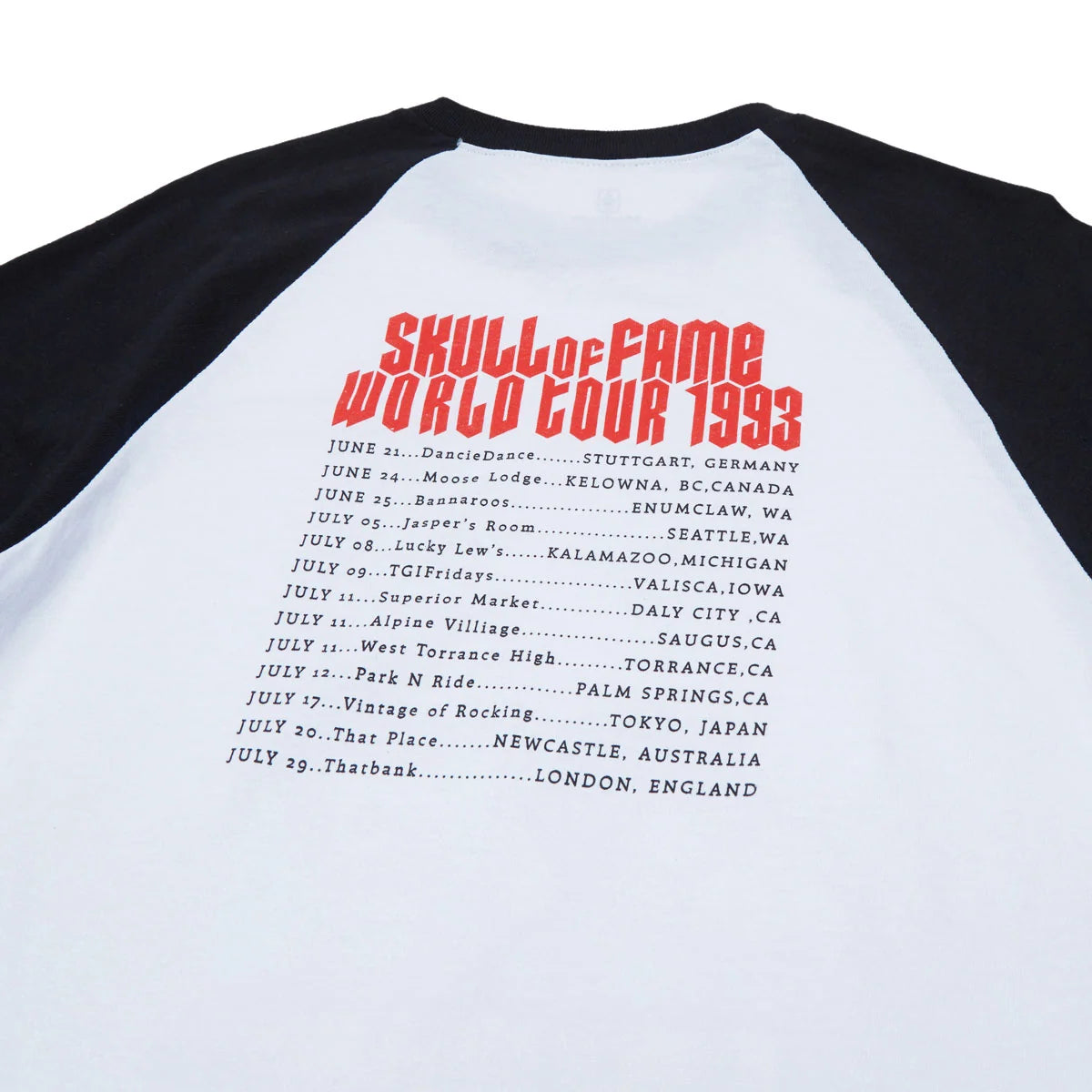 A close-up of a raglan baseball t-shirt showing the back panel with black sleeves and a white back. The back features a red graphic reading 'Skull of Fame World Tour 1993' above a black printed list of tour dates.