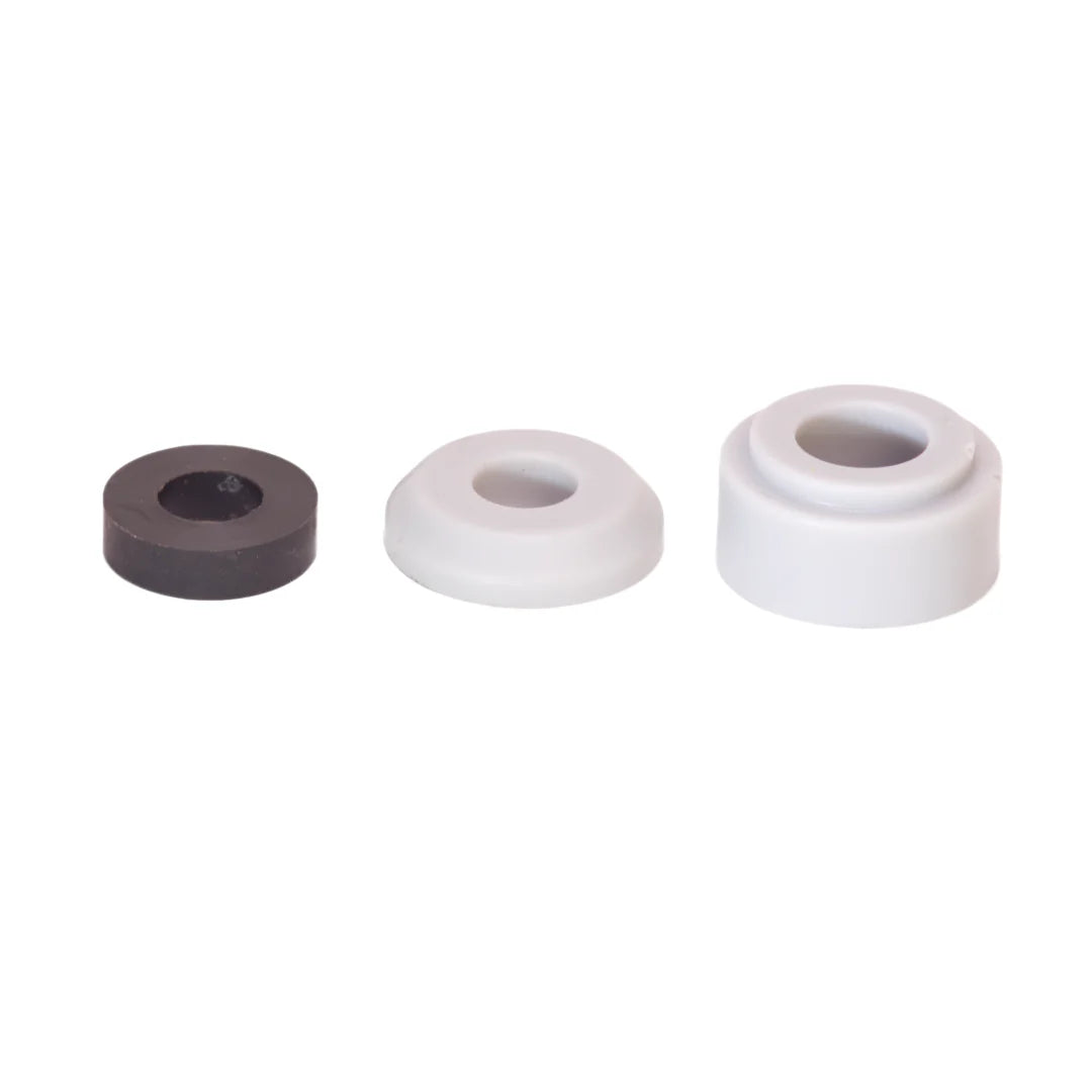 Three cylindrical rubber bushings in black, white, and gray on a white background