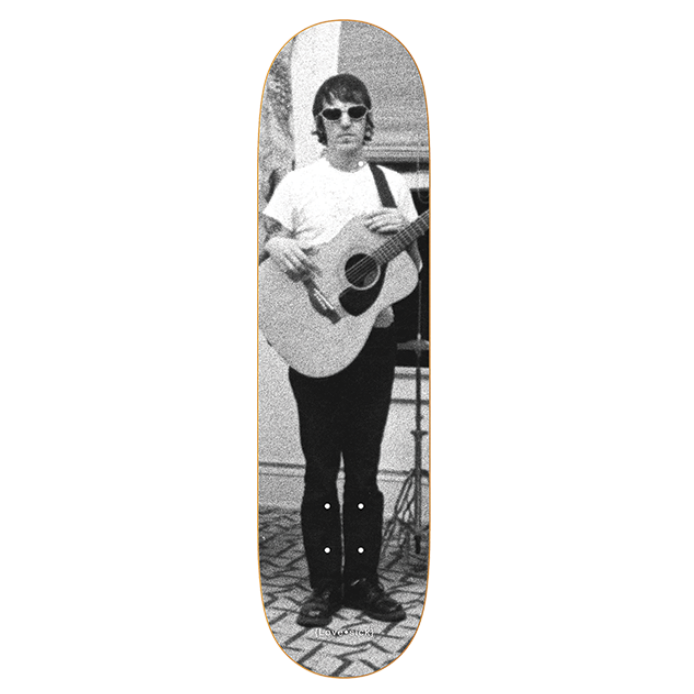 Skateboard deck with a black and white photo of a person playing guitar on a white background