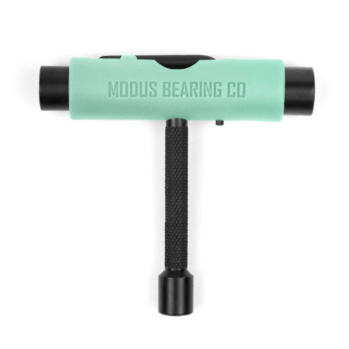 T-shaped tool with green handle and black ends on a white background