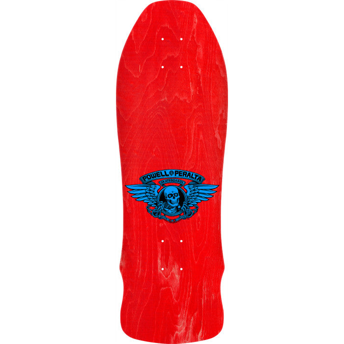 A red skateboard deck with a blue and black Powell Peralta winged skull graphic in the center, shown against a plain white background.