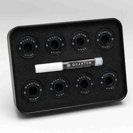 Black tray with Quantum branding containing six black circular components and a white marker on a light gray background.