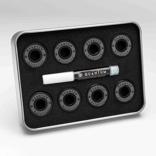 Set of Quantum skateboard bearings in a metal tray on a white background