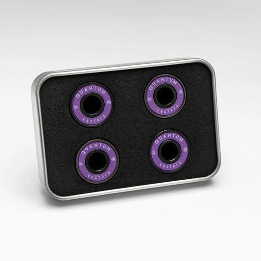 Four purple bearings on a black tray with 'Quantum' branding on a white background