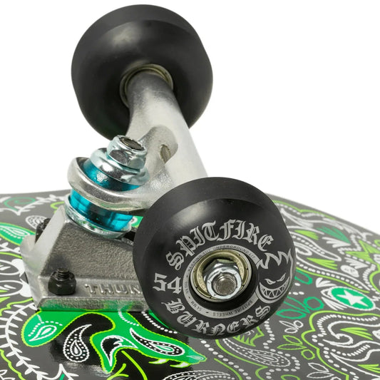 Close-up of a skateboard with a patterned deck and visible trucks on a white background
