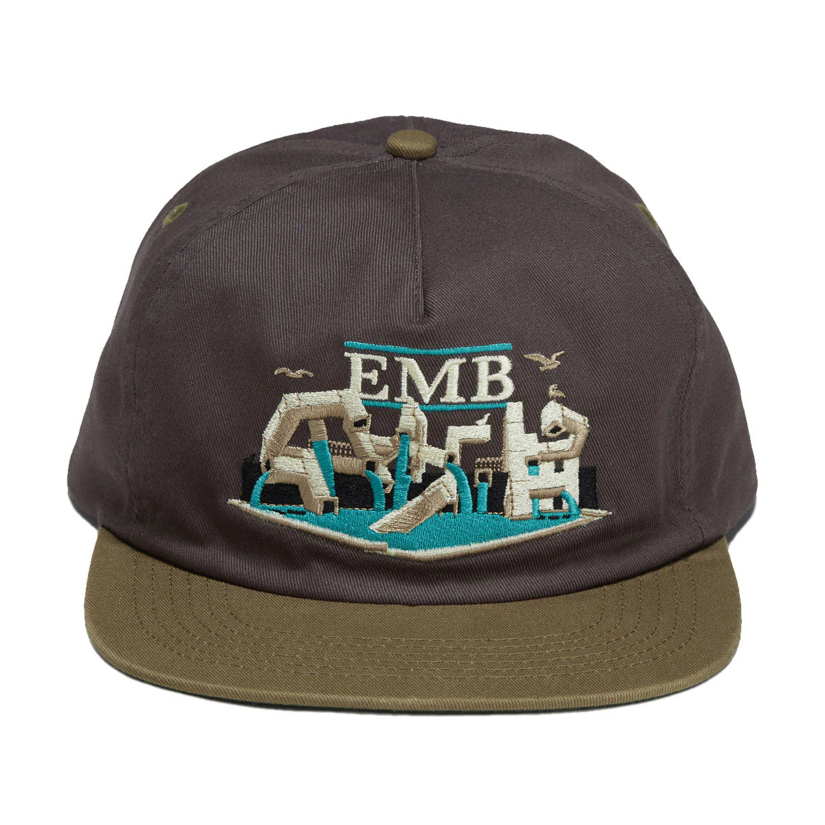 A dark brown snapback cap with an olive green flat brim, featuring a detailed embroidered graphic on the front with the letters 'EMB' and a stylized scene in beige, teal, and white.
