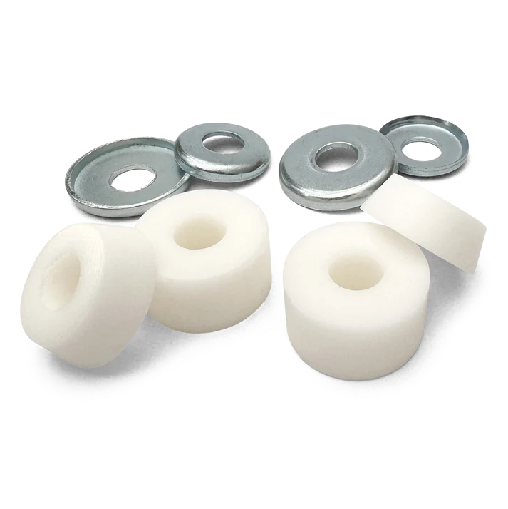 Set of white bushings and metal washers on a white background