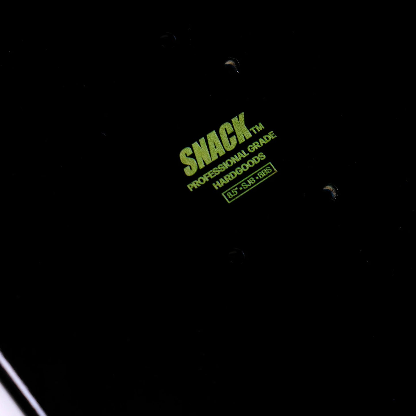 Black background with green 'SNACK' logo