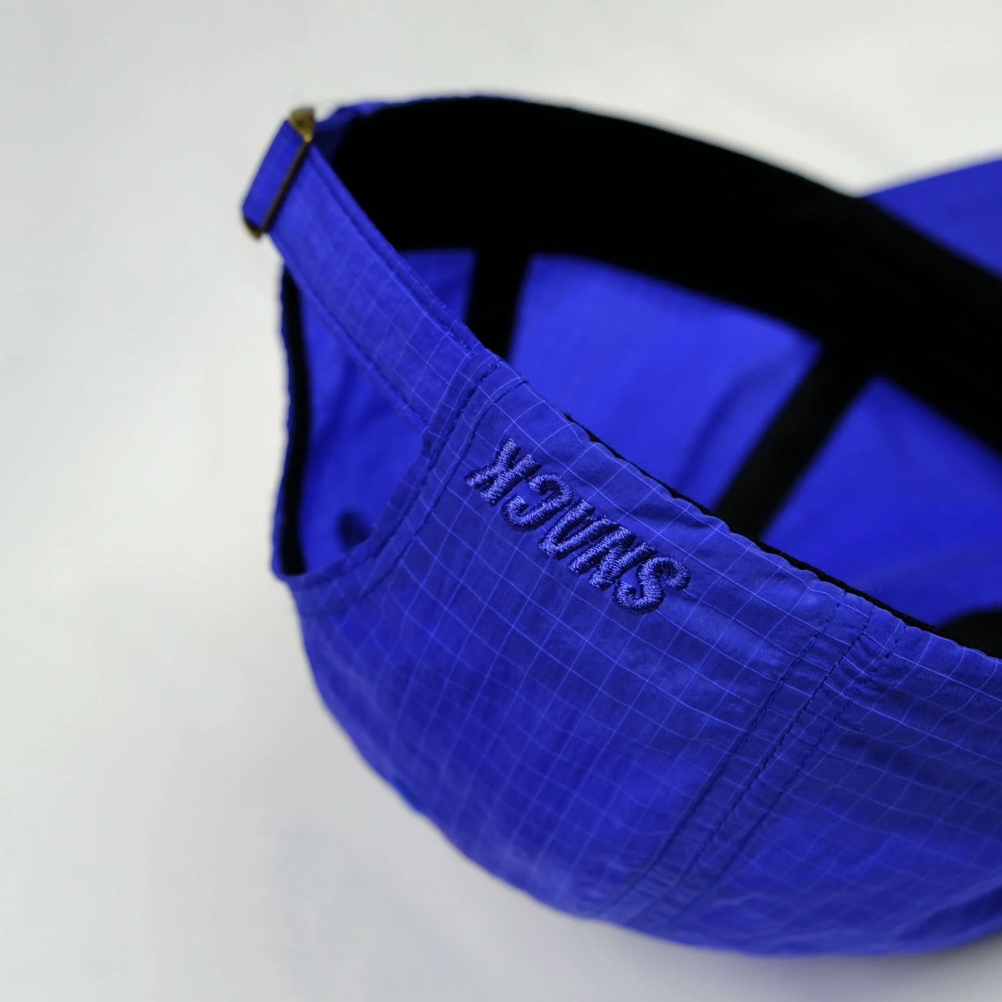 Blue cap with a strap on a white background