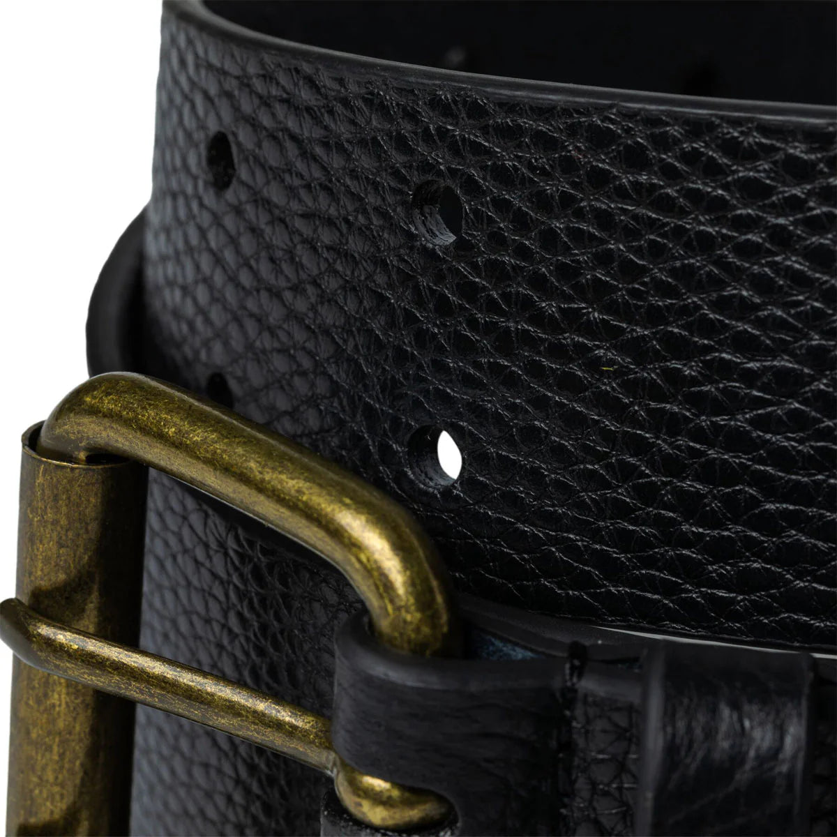 Close-up of a black leather belt with a brass buckle on a white background
