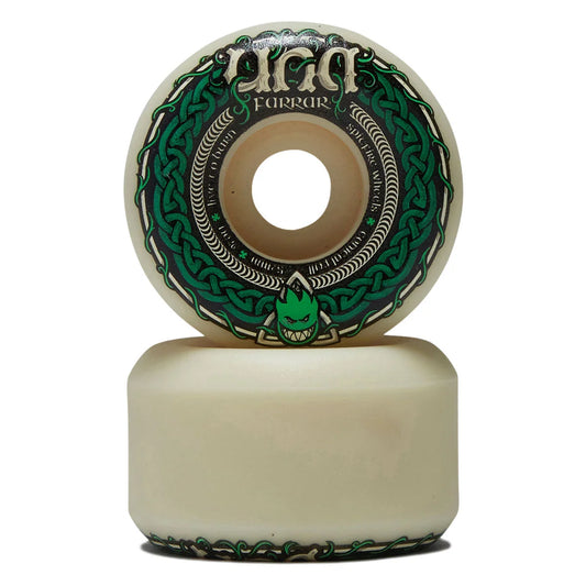 A pair of UGG Ferrar longboard wheels stacked vertically on a white background. The wheels feature a cream-colored urethane body with a prominent green and black Celtic knot graphic and the UGG logo.