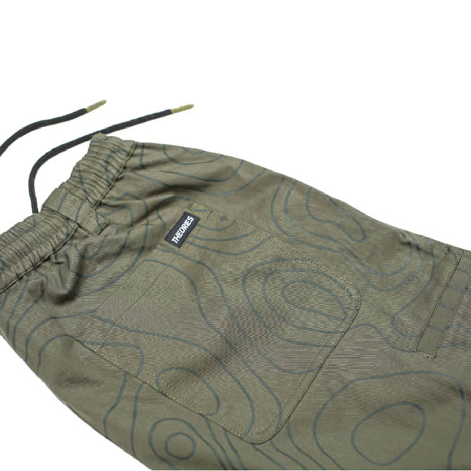 Green pants with a pattern and brand logo on a white background