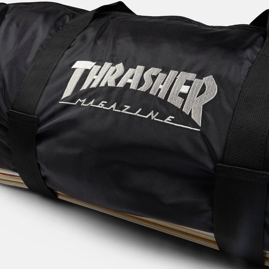 Black duffel bag with 'Thrasher Magazine' logo on a white background