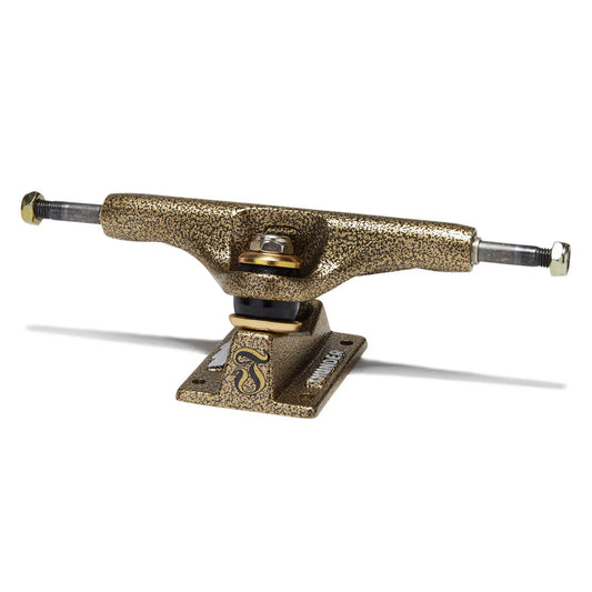 A single skateboard truck with a textured metallic gold finish, featuring a visible 'thunder' logo on the base plate, photographed on a clean white background.