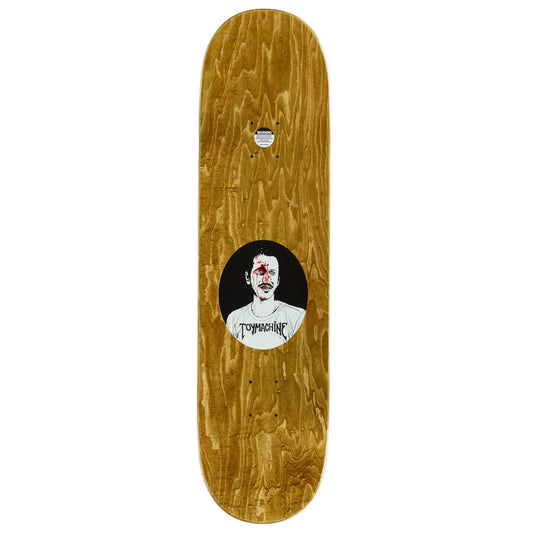 Skateboard deck with a wooden finish and a central graphic of a face with text, on a white background.
