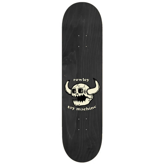 Black skateboard deck with a skull and horns design and 'rowley toy machine' text on a white background