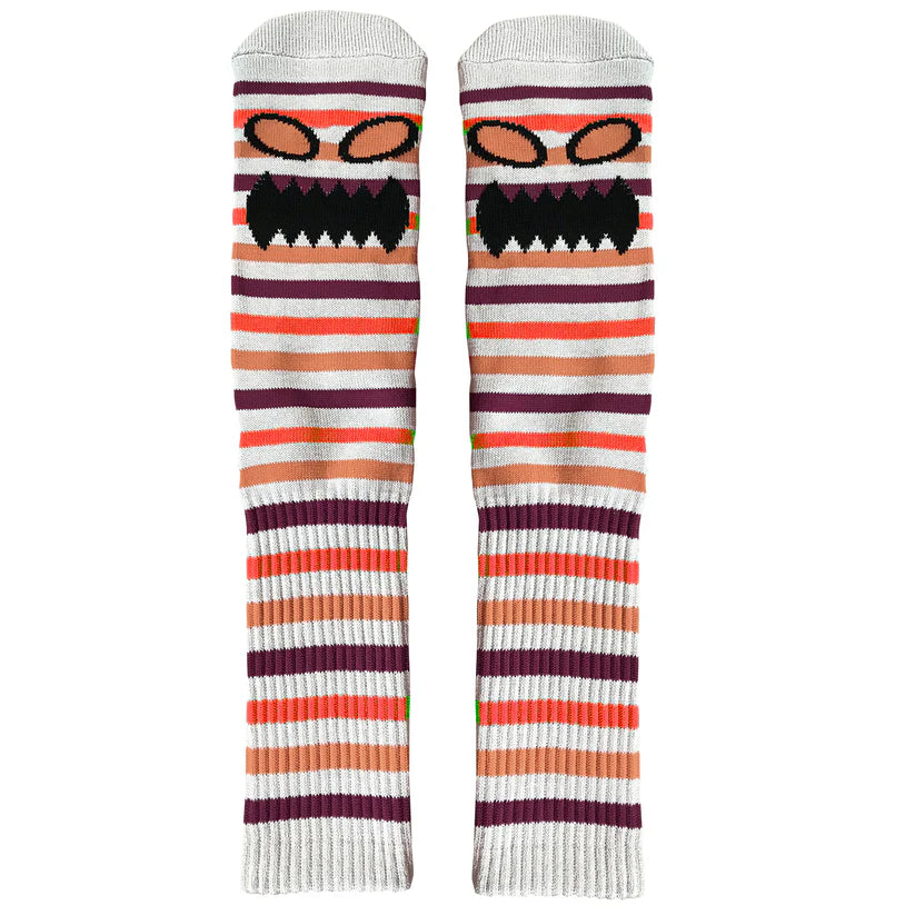 Pair of striped socks with a cartoon face design on a white background