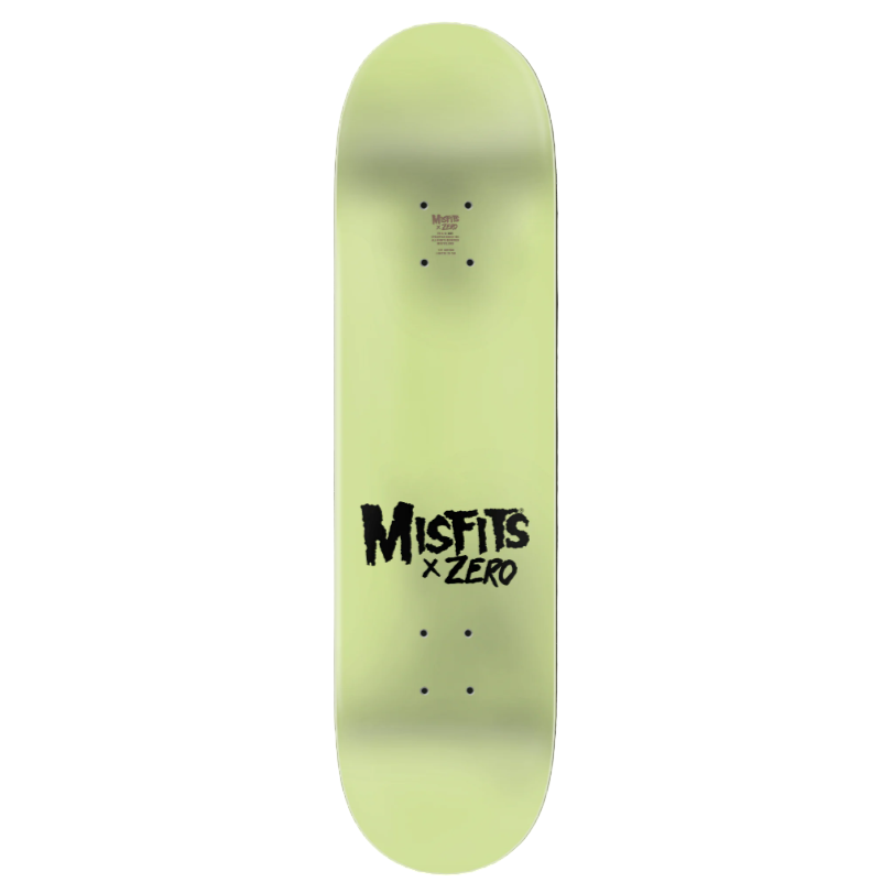 Glow-in-the-dark skateboard deck with 'Misfits x Zero' text on a black background