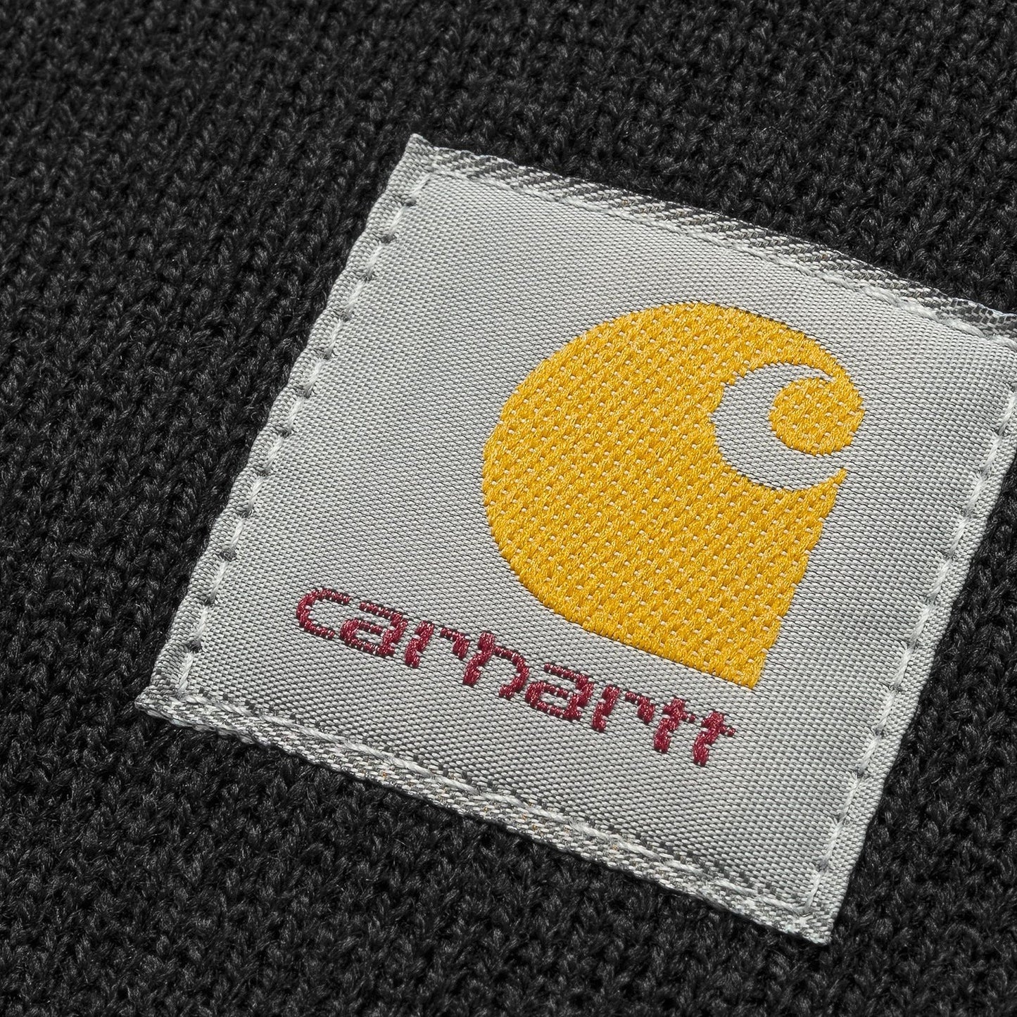 Carhartt logo patch on a black fabric background