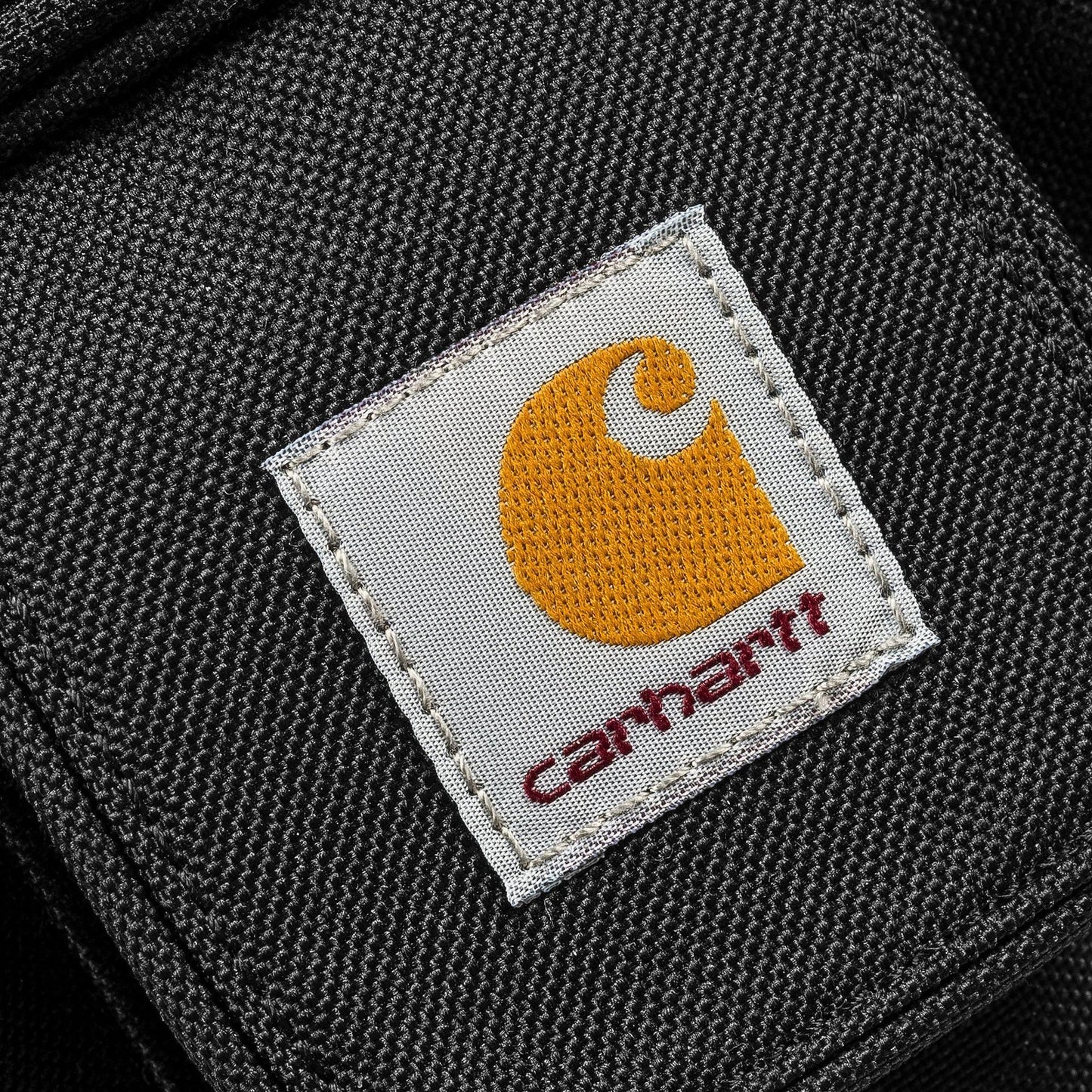 Carhartt logo on a product with a black background