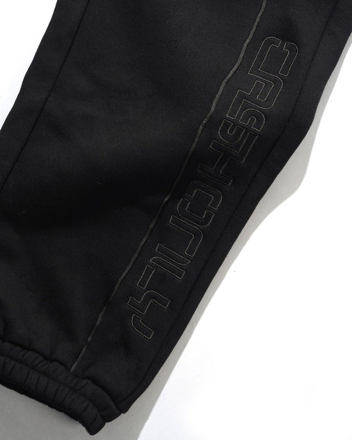 Black pants with a brand logo on a white background