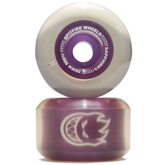 A pair of Spitfire Wheels skateboard wheels stacked vertically. The top wheel shows the purple inner core with white text reading 'SPITFIRE WHEELS' and 'SAPPHIRES 55MM 9A'.