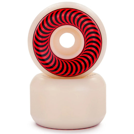 A pair of cream-colored skateboard wheels stacked vertically, with the top wheel showing a red and black spiral pattern on its inner ring, set against a plain white background.