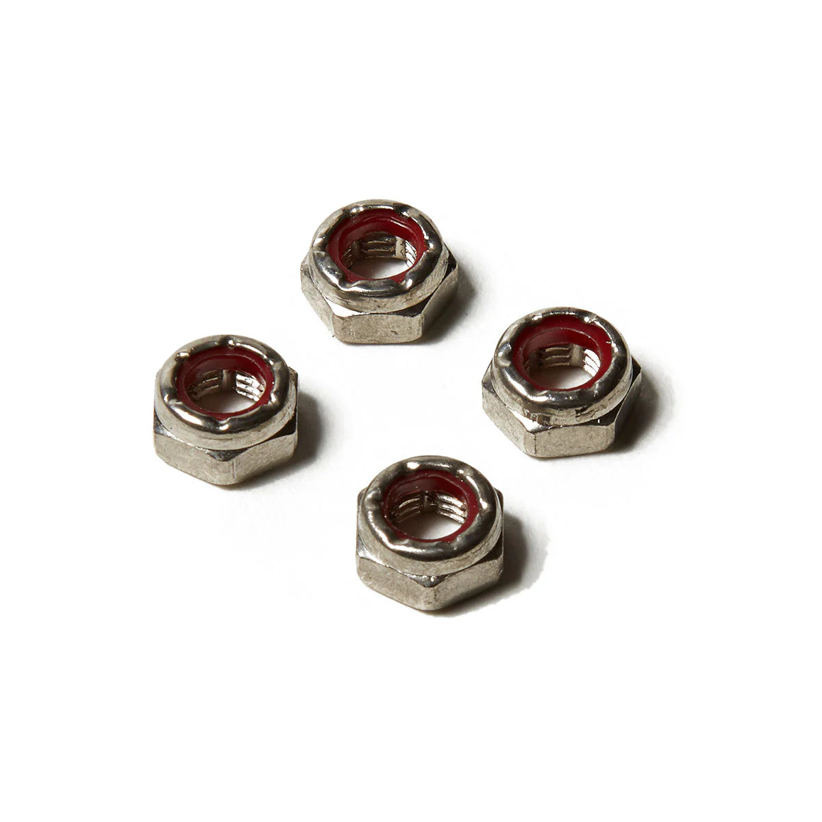Four metal hex nuts on a white background