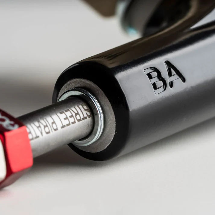 Close-up of a bicycle suspension fork with 'BA' branding on a blurred background