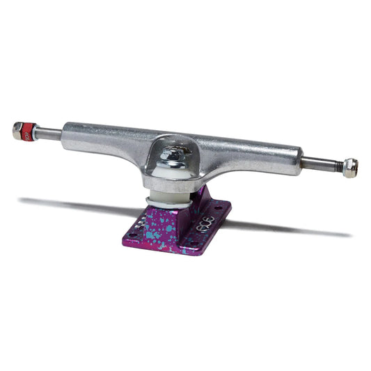 A single skateboard truck with a silver metallic chrome hardware and a purple anodized base plate featuring blue and white paint splatters, shown on a white background with a soft shadow.